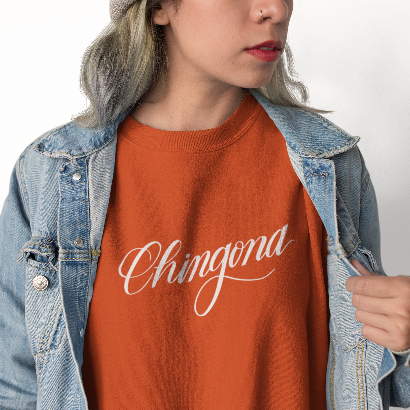 Image of Person wearing Chingona sweatshirt in color brick. | The Outrage