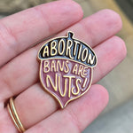 Load image into Gallery viewer, Acorn shaped enamel pin with &quot;abortion bans are nuts&quot; design
