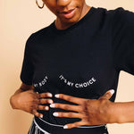 Load image into Gallery viewer, Person wearing The Outrage's It's My Body It's My Choice unisex tee in black.