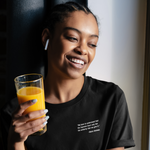 Load image into Gallery viewer, Photo of a person wearing the SCOTUS Jenga Unisex Tee. The front has a small quote on the upper left chest that says "We have to understand that the Supreme Court only has the authority that we give it" —Gloria Steinem