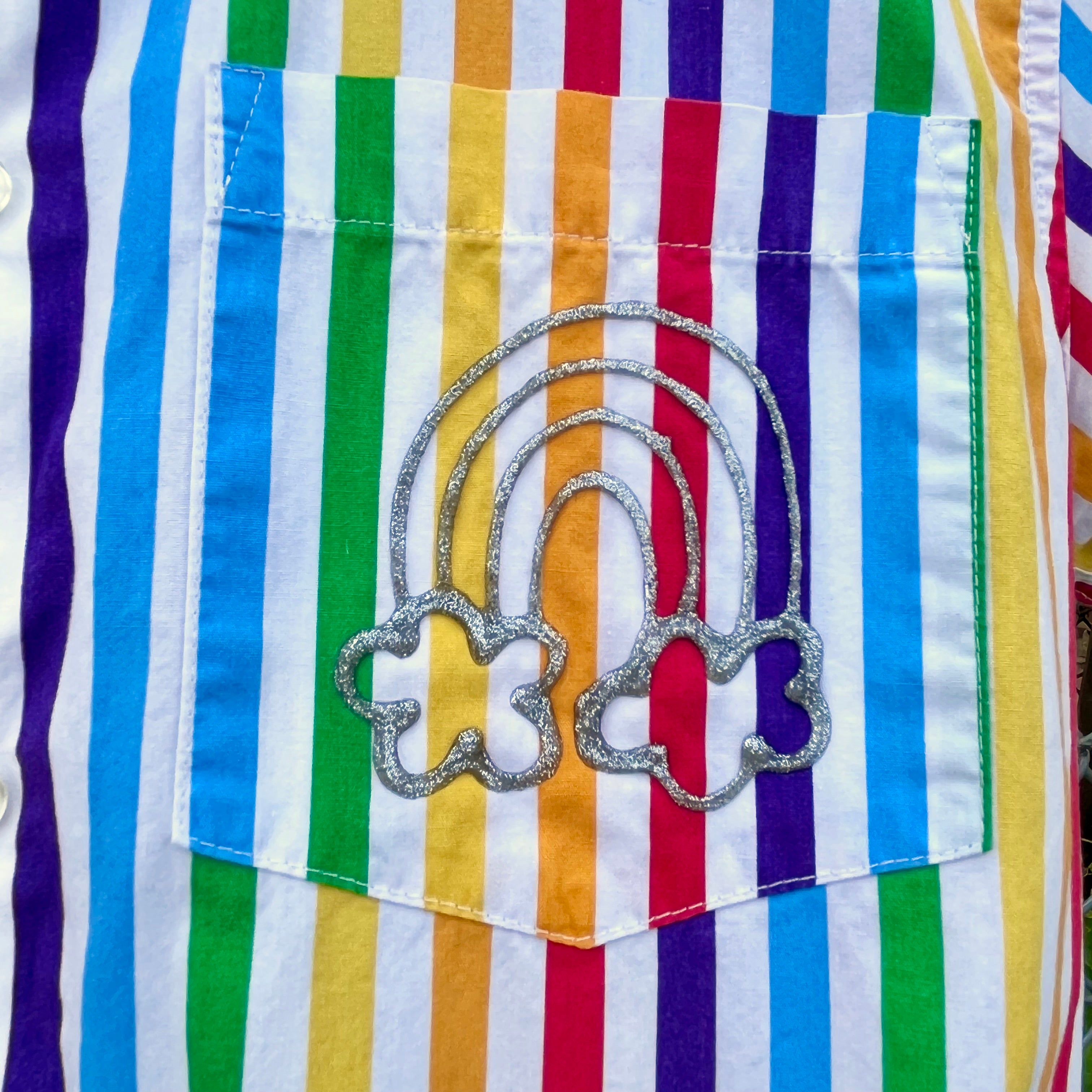 Silver glitter rainbow detail on the front pocket