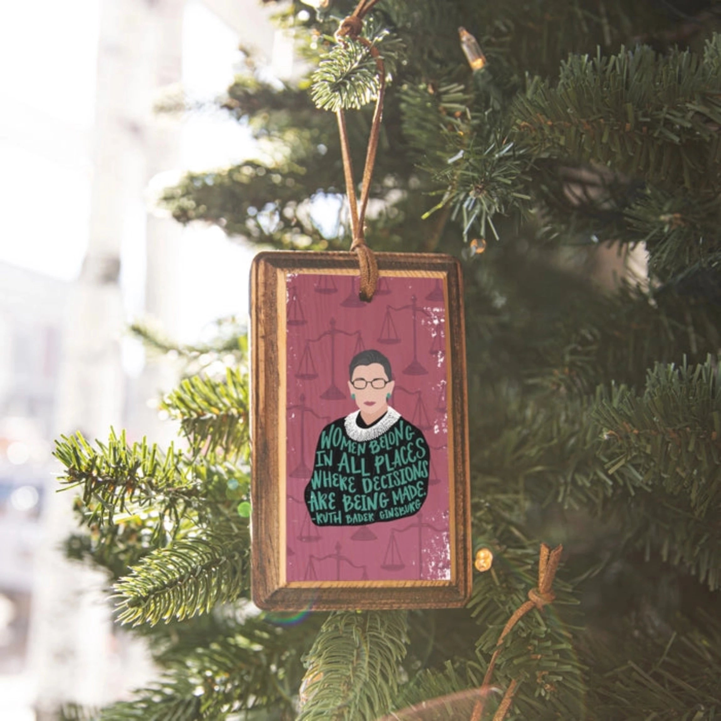 Rectangular wooden ornament with illustrated portrait of Ruth Bader Ginsberg and quote 
