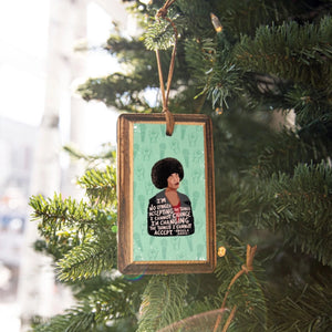 Rectangular wooden ornament with illustrated portrait of Angela Davis and quote 