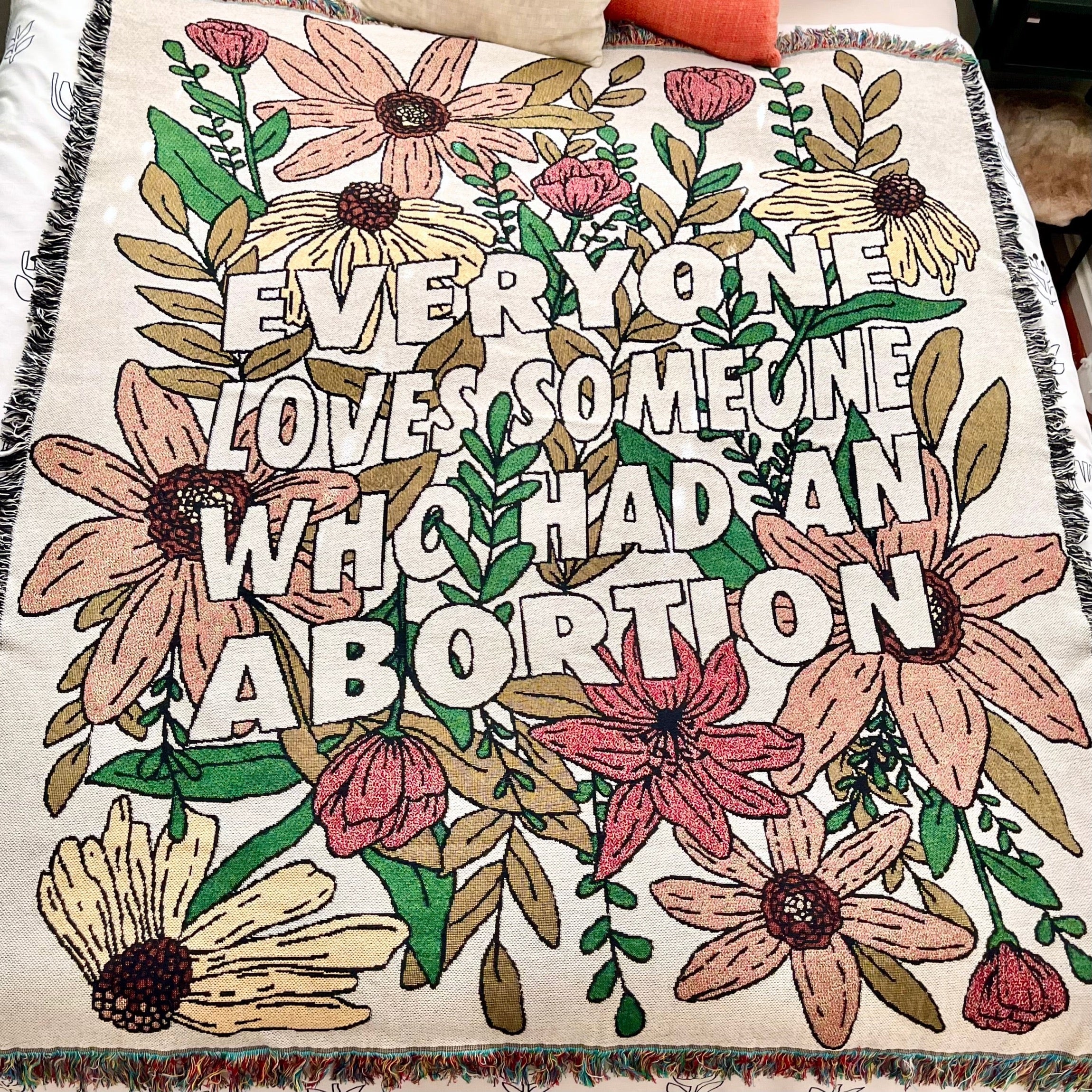 Cotton throw blanket with fringe and floral design with "Everyone Loves Someone Who Had An Abortion"