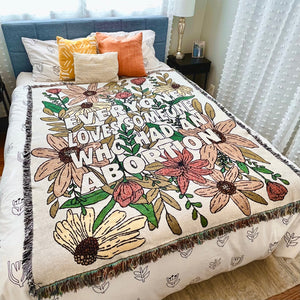 Cotton throw blanket with fringe and floral design with "Everyone Loves Someone Who Had An Abortion"