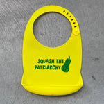 Load image into Gallery viewer,  Yellow silicon bib with pocket and green design &quot;Squash The Patriarchy&quot;
