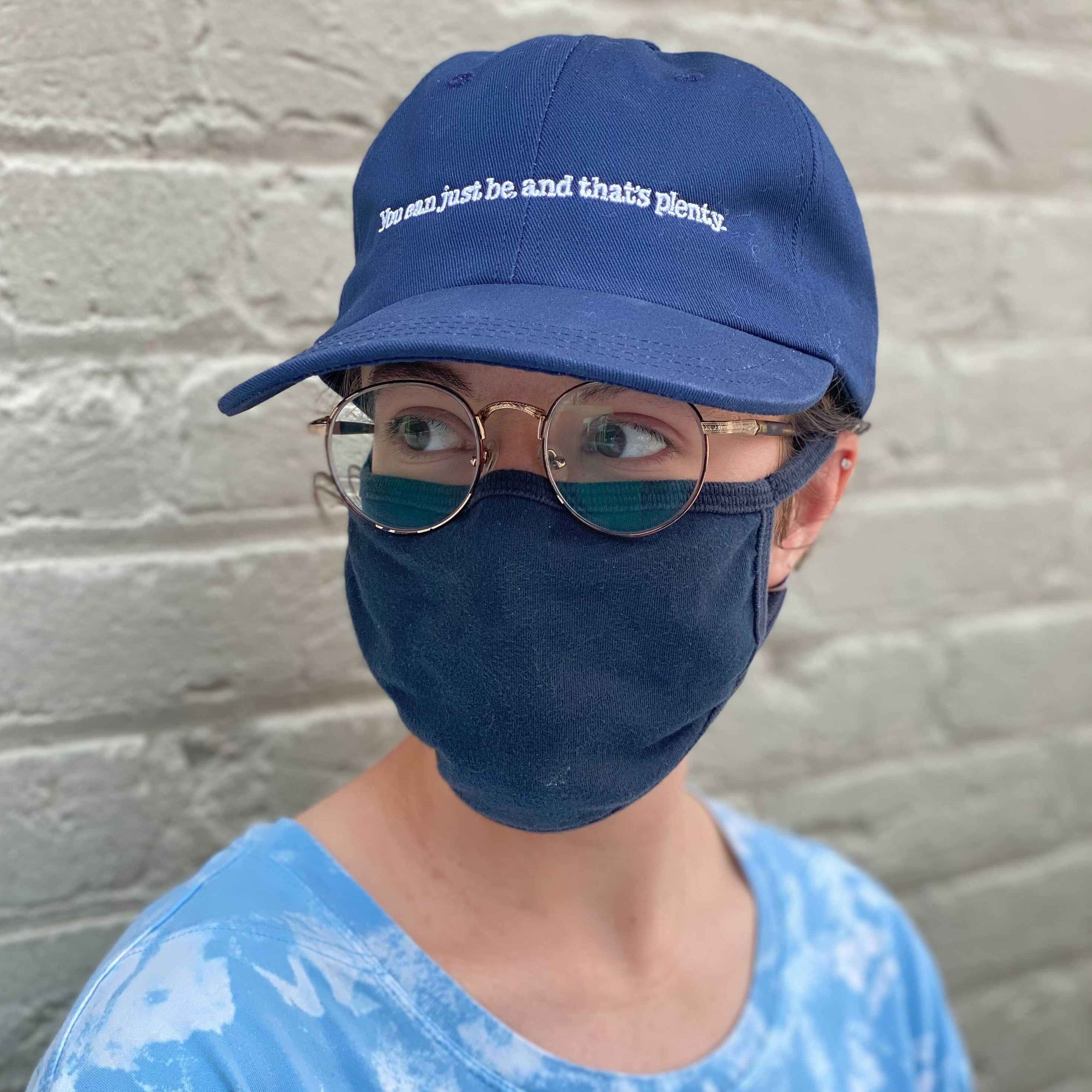 Person wearing Alice Walker "You can just be, and that's plenty" cap