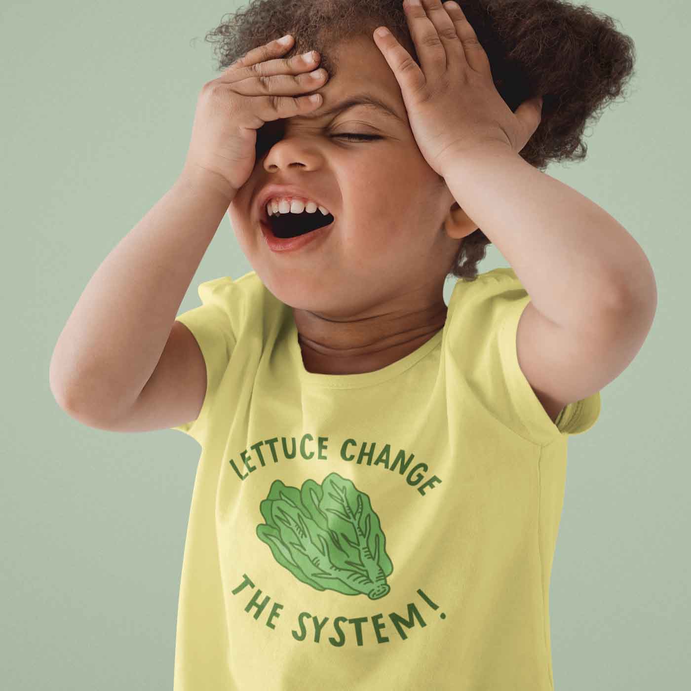 Kid wearing Lettuce Change the System toddler tee