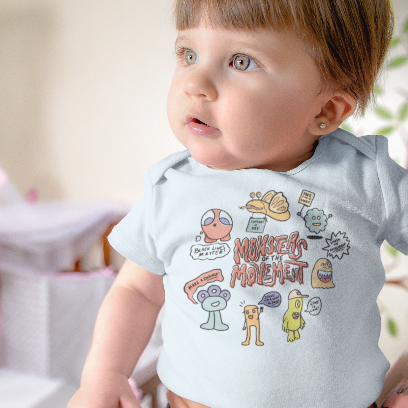 Baby wearing Monsters of the Movement onesie