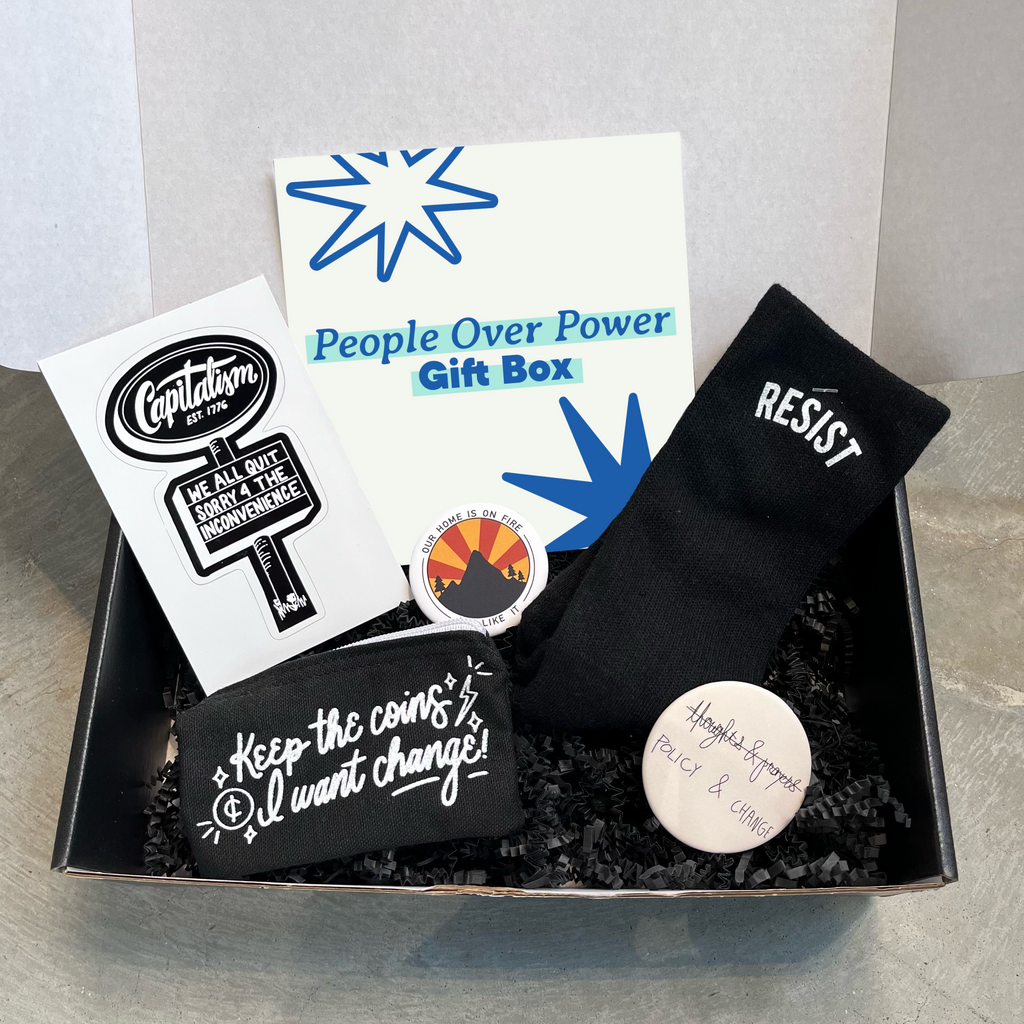 Gift box including: black socks with "Resist" design, Policy and change button, Our Home is on Fire button, coin purse with "Keep the Coins, I want Change!" design, and We all quit Capitalism sticker.