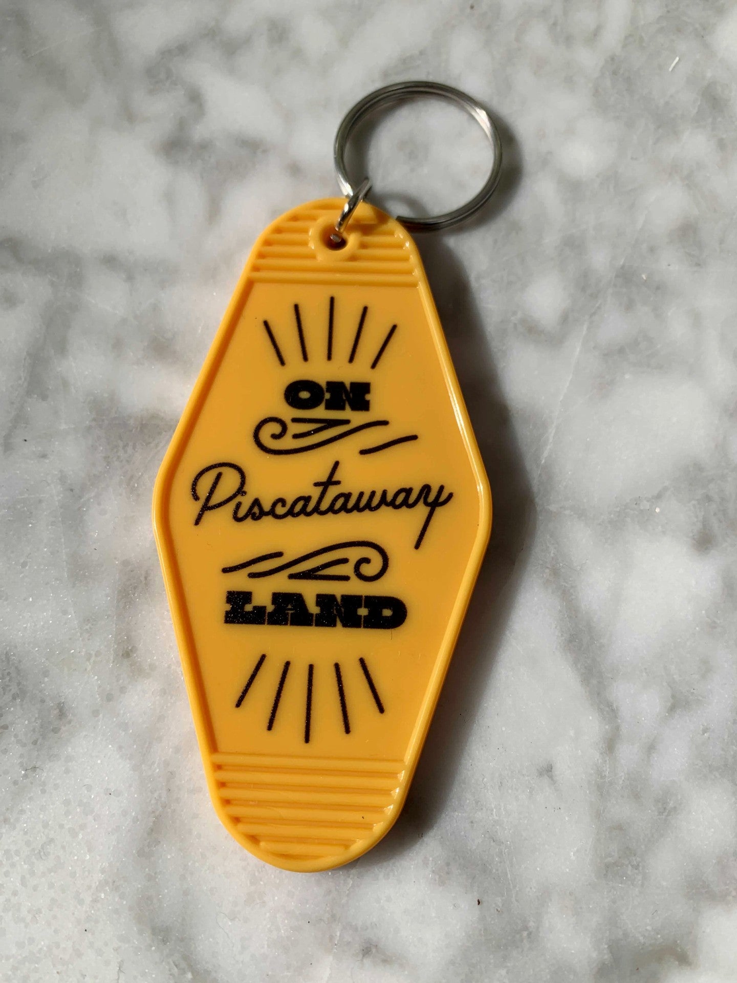Yellow Native Land keychains — On Piscataway Land
