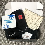 Load image into Gallery viewer, Photo of the Reproductive Justice Gift Box card, the My Body My Choice Unisex Tee, the Elephant in the Womb pin, the ASL Pro-choice Sticker Pack, and the Boob Print Makeup Pouch all placed in a gift box.
