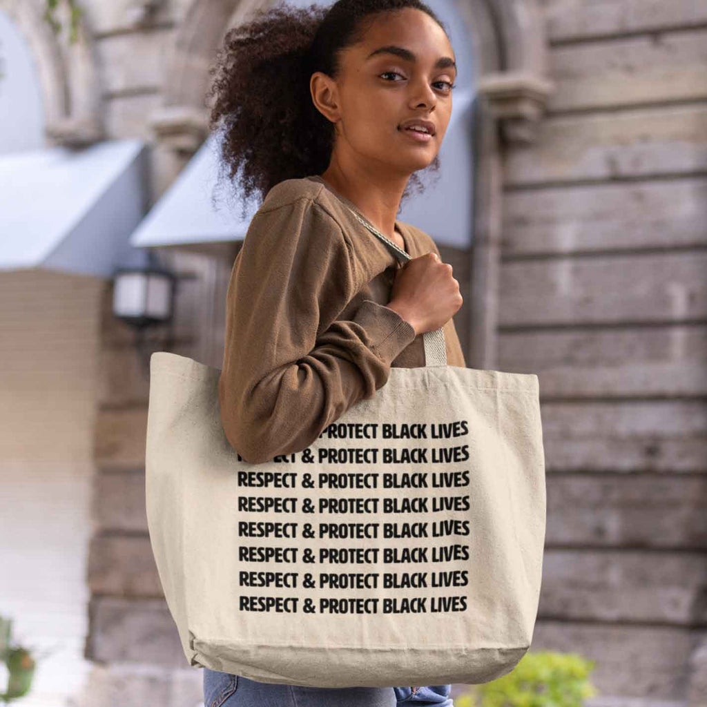 Person holding the Respect and Protect Black Lives tote bag