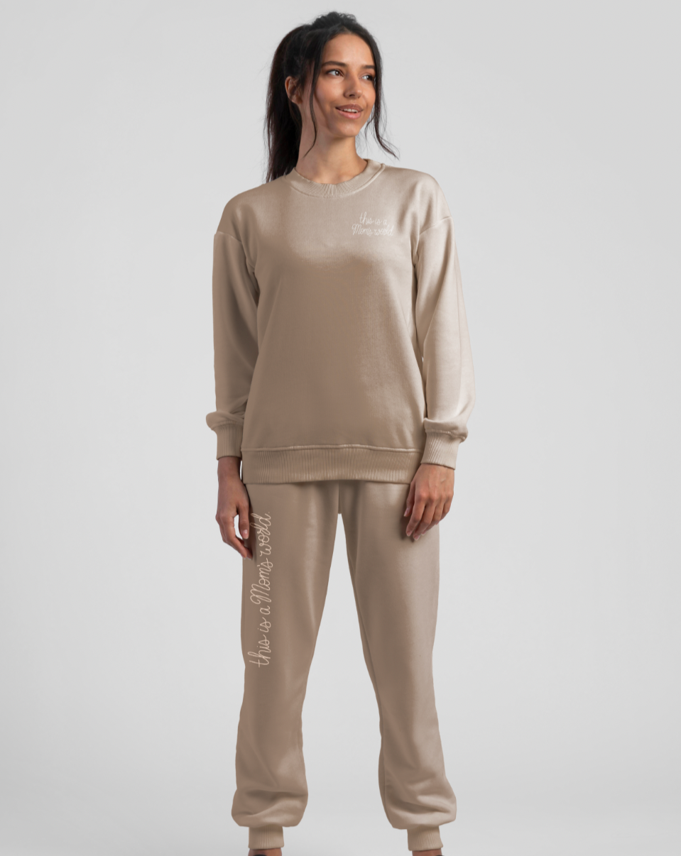Person standing wearing Ma'am Shoes "This Is A Mom's World" sweatpants and sweatshirt.
