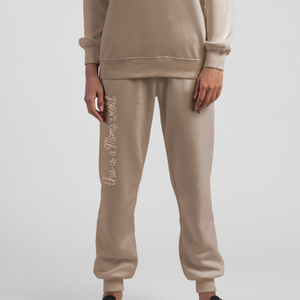 Person standing wearing Ma'am Shoes "This Is A Mom's World" sweatpants and sweatshirt.