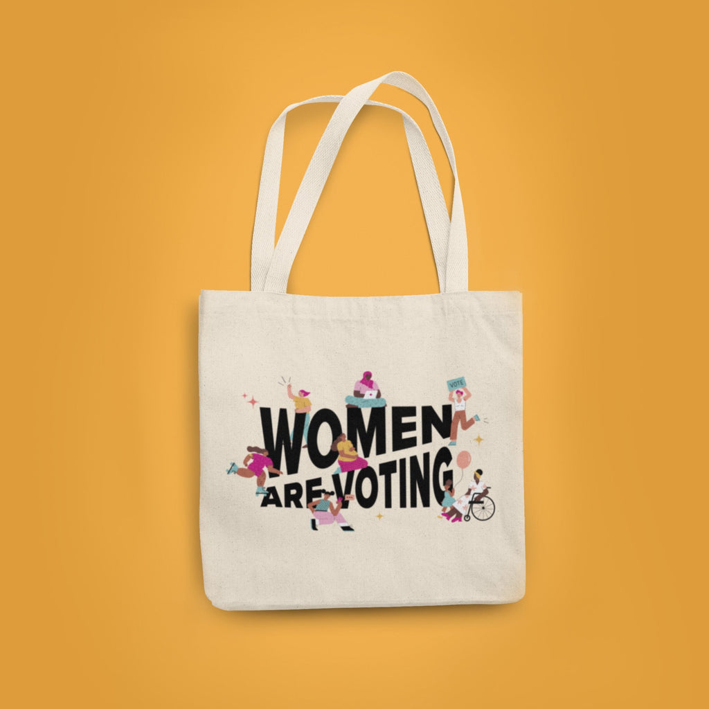 Yellow background with a natural canvas tote with "Women Are Voting" in black with inclusive femme figures surrounding.