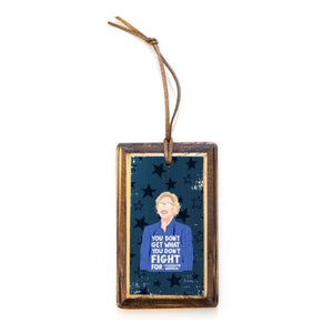 Rectangular wooden ornament with illustrated portrait of Elizabeth Warren and quote 