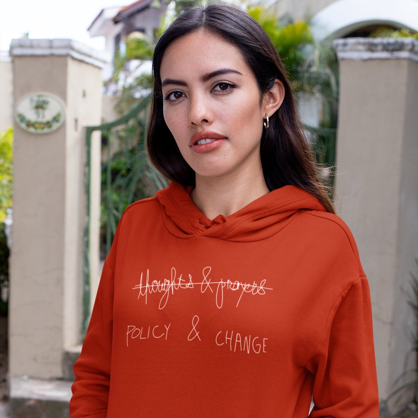 Photo of a woman wearing the Policy and Change Hoodie.