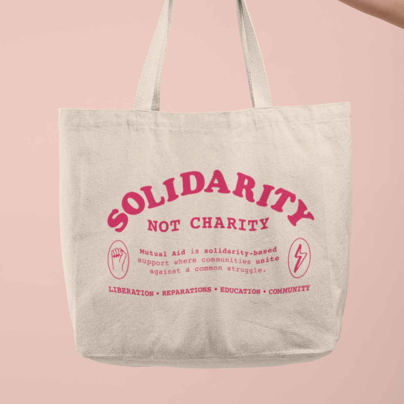 Solidarity Not Charity tote bag