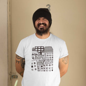 Person wearing Housing Is A Human Right Tee