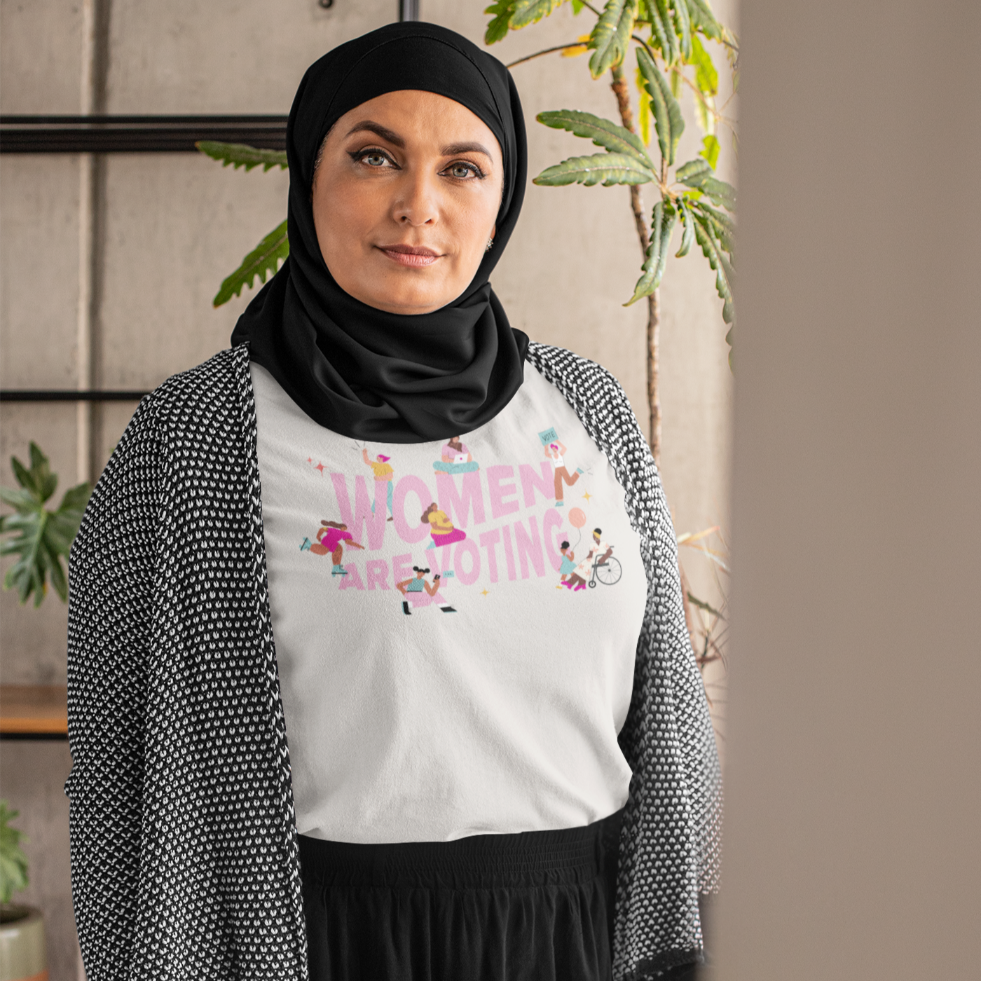 Photo of a woman with a black hijab who is wearing the Women Are Voting Unisex T-shirt.